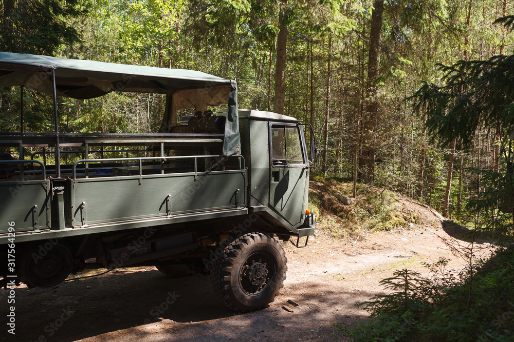 Heavy military truck in the pine forest. Naissaar island, Estonia, formerly military zone