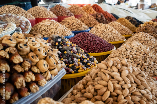 View of colorful sweets and nuts on showcase of local food market, Uzbekistan