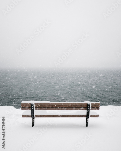 Bench chair covered in snow in Stanley park