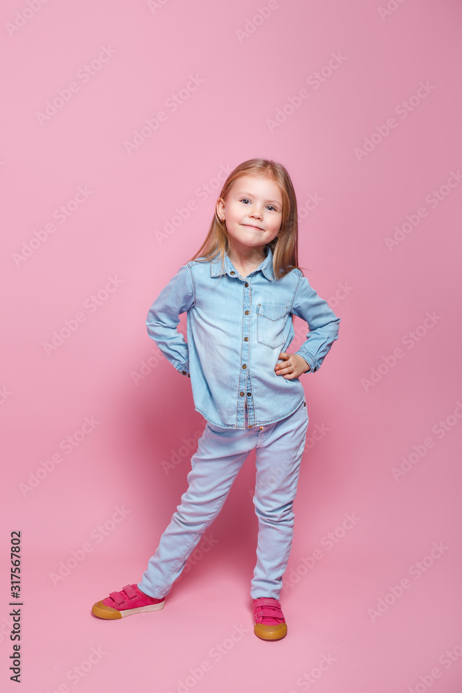 Cute little girl in blue clothes smiling on camera Cute little girl in blue clothes smiling on camera