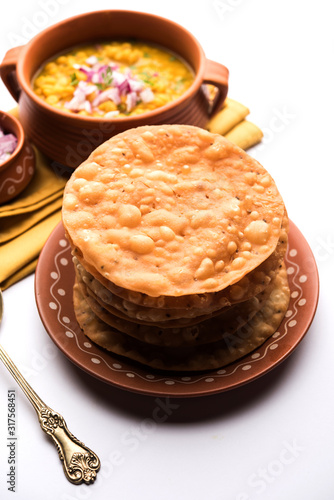 Dal pakwan is an authentic Sindhi breakfast. It is a combination of deepfried, crisp and unpuffed Maida puris served with Daal made using chana or split chickpea. selective focus