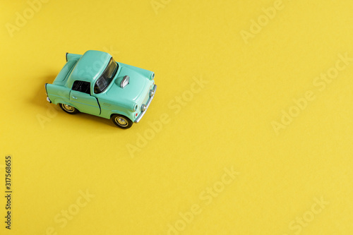 Toy car on yellow background