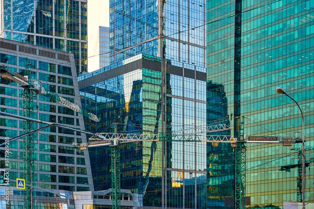 Moscow, Russia - September 12, 2019: Construction tower cranes on a background of buildings. District of Moscow International Business Center Moscow-City.