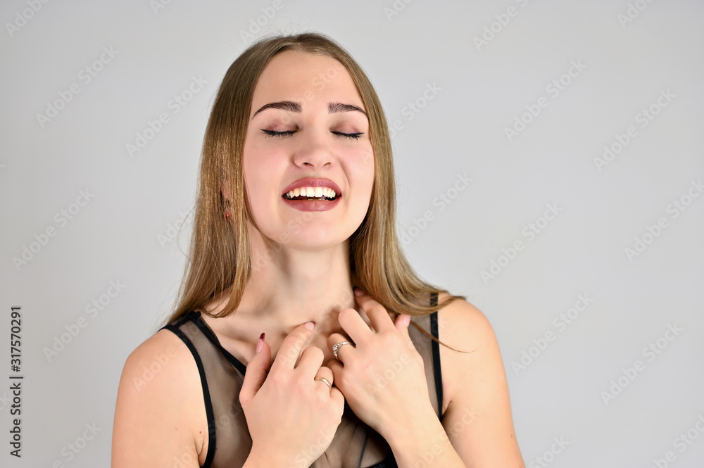 A large photo of a pretty smiling girl with long hair and excellent make-up is standing in different poses. Generic female portrait concept for cosmetics advertising on a white background. A large photo of a pretty smiling girl with long hair and excellent make-up is standing in different poses. Generic female portrait concept for cosmetics advertising on a white background.