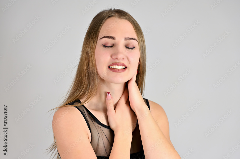 A large photo of a pretty smiling girl with long hair and excellent make-up is standing in different poses. Generic female portrait concept for cosmetics advertising on a white background. A large photo of a pretty smiling girl with long hair and excellent make-up is standing in different poses. Generic female portrait concept for cosmetics advertising on a white background.