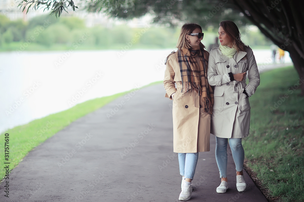autumn fashion park girls two look / walk in a city park two glamorous fashionable girlfriends in a coat autumn fashion park girls two look / walk in a city park two glamorous fashionable girlfriends in a coat