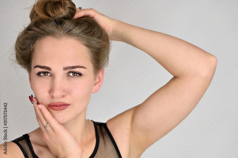 Generic female portrait concept for cosmetics advertising on a white background. A large photo of a pretty smiling girl with long hair and excellent make-up is standing in different poses. Generic female portrait concept for cosmetics advertising on a white background. A large photo of a pretty smiling girl with long hair and excellent make-up is standing in different poses.
