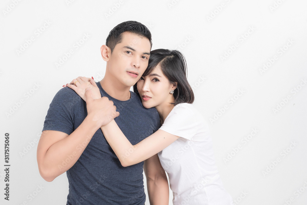 Portrait of happy young couple embracing in studio shot on white background. Portrait of happy young couple embracing in studio shot on white background.