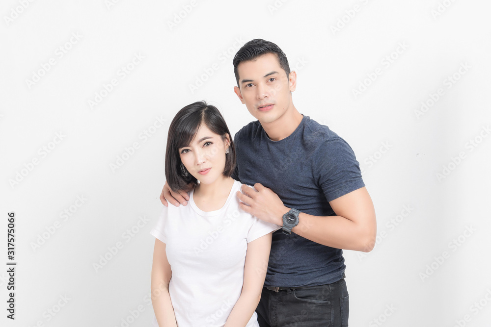 Portrait of happy young couple embracing in studio shot on white background. Portrait of happy young couple embracing in studio shot on white background.
