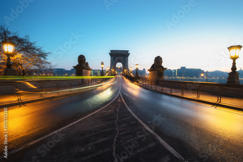 Beautiful Long exposure image of Chain Bridge in Budapest  Hungary. View of light trails along the road. Dawn photography.