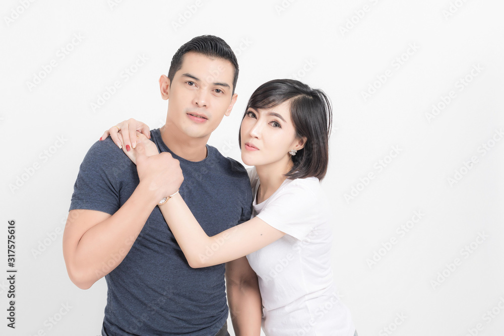 Portrait of happy young couple embracing in studio shot on white background. Portrait of happy young couple embracing in studio shot on white background.