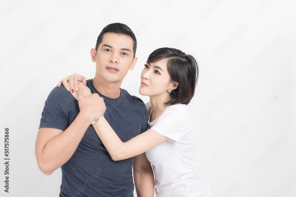 Portrait of happy young couple embracing in studio shot on white background. Portrait of happy young couple embracing in studio shot on white background.