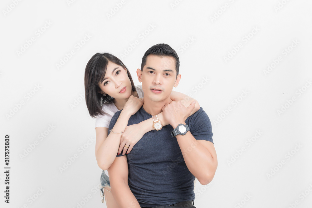 Portrait of happy young couple embracing in studio shot on white background. Portrait of happy young couple embracing in studio shot on white background.