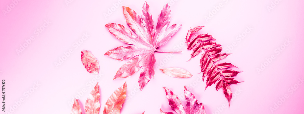 Beautiful Leaf painted in golden and copper metallic paint on pink background. Top view, copy space, flat lay, banner