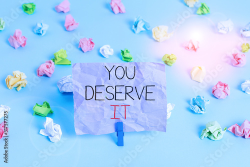 Writing note showing You Deserve It. Business concept for Reward for something well done Deserve Recognition award Colored crumpled papers empty reminder blue floor background clothespin