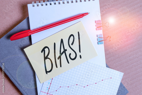 Word writing text Bias. Business photo showcasing inclination or prejudice for or against one demonstrating group Desk notebook paper office cardboard paperboard study supplies table chart