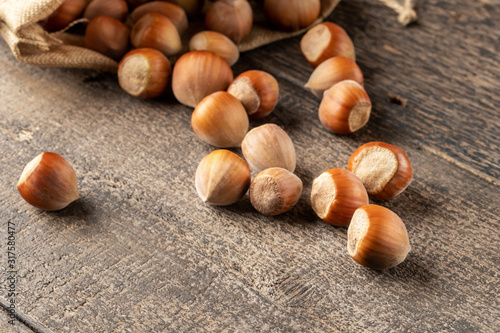 Hazelnuts on a wooden background with copy space