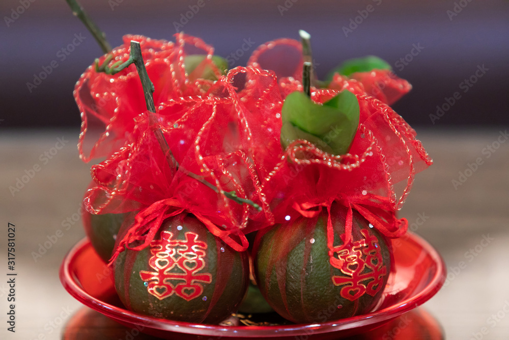 Tangerine Fruits in tray wrapped in red clothes, with Chinese Character stickers meaning Double Happiness, in Chinese Wedding Ceremony as appropriate for marriage gift. Symbol of Luck and Prosperity. Tangerine Fruits in tray wrapped in red clothes, with Chinese Character stickers meaning Double Happiness, in Chinese Wedding Ceremony as appropriate for marriage gift. Symbol of Luck and Prosperity.
