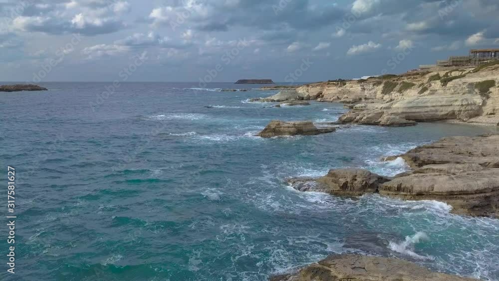 Flight over the Mediterranean coast. Waves crash on beautiful white rocks. 4K Flight over the Mediterranean coast. Waves crash on beautiful white rocks. 4K