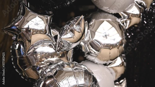 mirror inflatable helium balloons resembling stars at a holiday