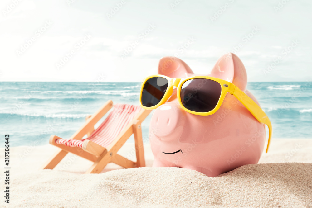 Piggy bank on vacation. Finance and travel concept