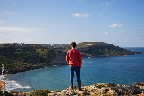 man standing on cliff enjoy the beautiful scenery