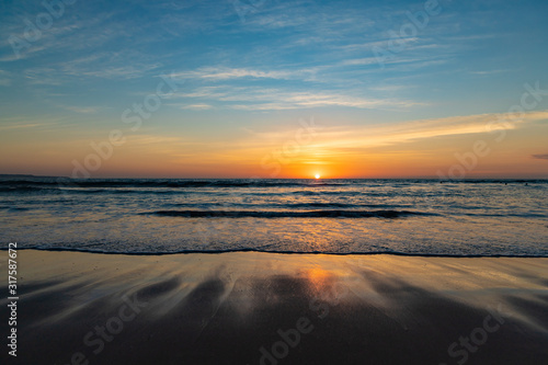 Beautiful sunset on the ocean Kuta beach of Bali island, Indonesia