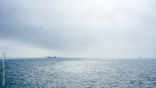 Ships navigate on the open sea. photo