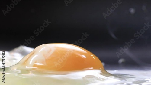 Egg fried on skillet sunny side up close up view