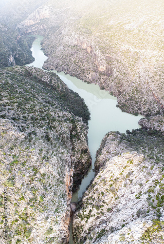 Aerial view of Isbert reservoir in Barranc de l'Infern (The Hell's Ravine), La Vall de Laguar, Spain. The dam is overflown. photo