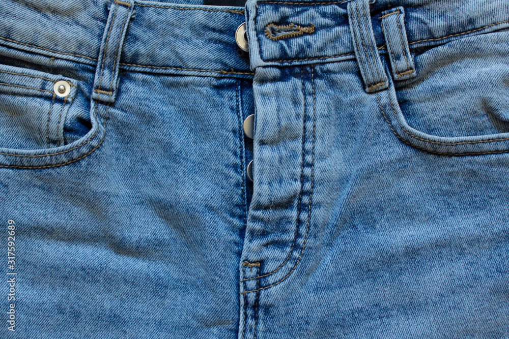 part of jeans with beautiful embossed stitching, seam, fabric texture, close-up, copy space