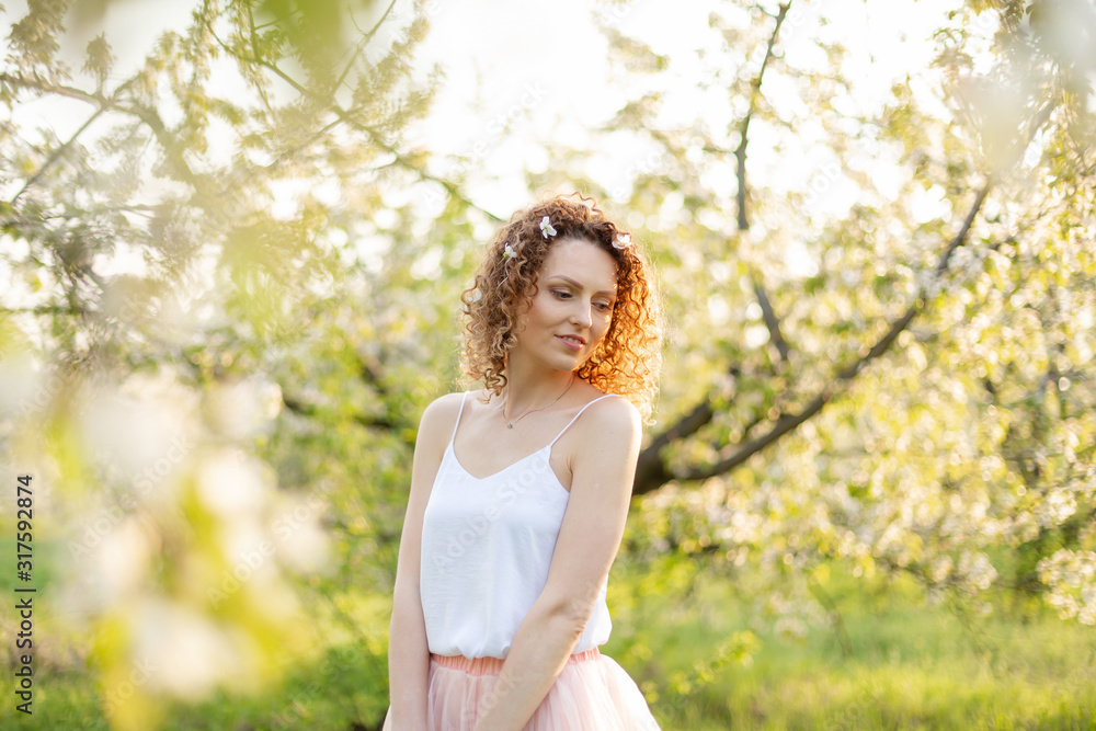 Young attractive girl walks in spring green park enjoying flowering nature. Healthy smiling girl spinning on the spring lawn. Allergy without Young attractive girl walks in spring green park enjoying flowering nature. Healthy smiling girl spinning on the spring lawn. Allergy without