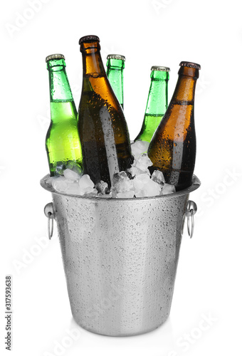 Beer in metal bucket with ice isolated on white