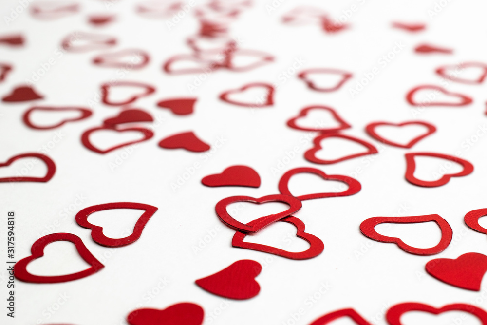 Valentines day heart. Heart shape red confetti splash on white background. Happy Valentines Day greeting card background. Valentines day heart. Heart shape red confetti splash on white background. Happy Valentines Day greeting card background.