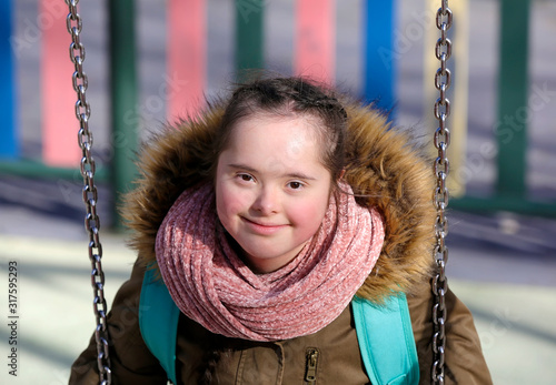 Nice girl having fun on the playgound photo