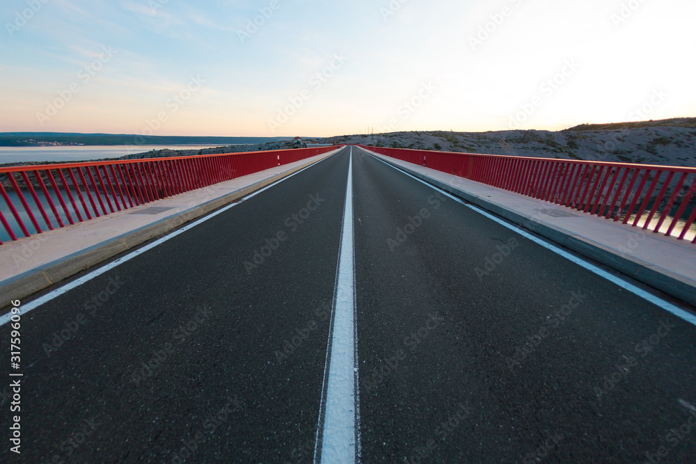 Fototapeta premium Red Bridge over the canyon in Croatia at sunset.