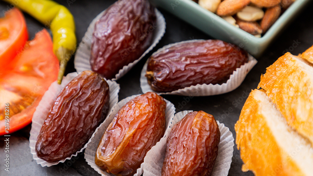 Fruit image Date Palm Welding Fruit is sweet and without sugar for health and is a diet on a beautiful stone tray on the table. Fruit image Date Palm Welding Fruit is sweet and without sugar for health and is a diet on a beautiful stone tray on the table.