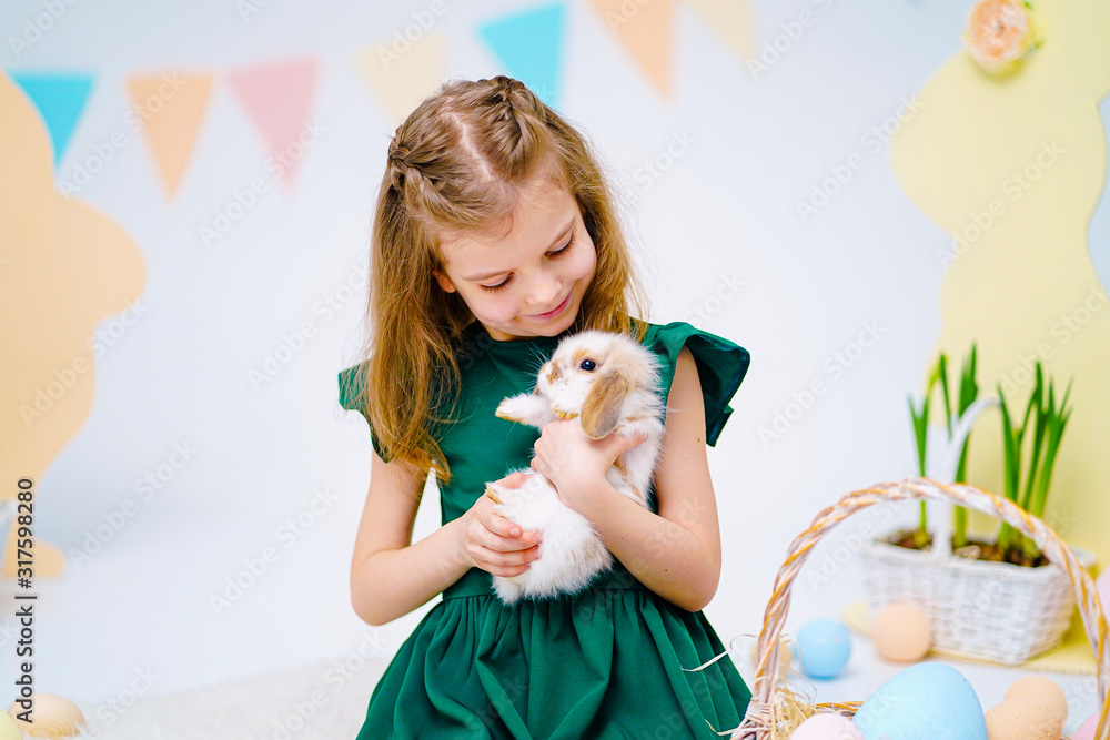 the girl with the rabbit. happy little girl holding cute fluffy Bunny ...