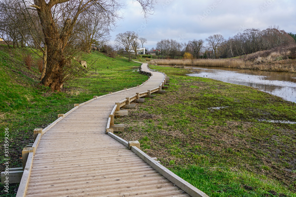 new curved wooden footpath for walk in nature park new curved wooden footpath for walk in nature park
