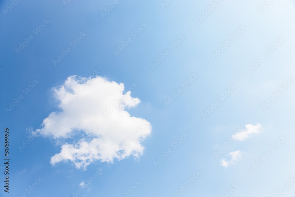 Blue sky background. Blue sky with fluffy white clouds. Copy space
