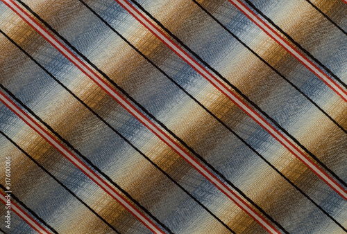  multi-colored fabric with black, white and red stripes diagonally