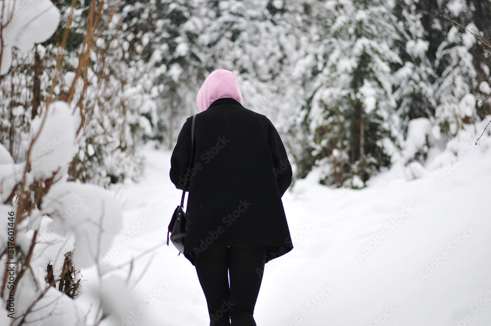 Girl in a snow-covered mountain forest