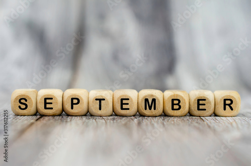 The word September on wooden cubes. Month of year photo