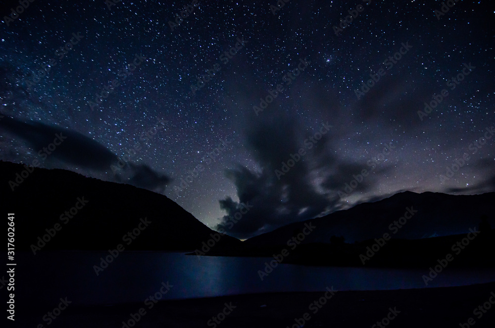 Night sky with clouds above lake in albanian nature near Fushe Stude, Albania Night sky with clouds above lake in albanian nature near Fushe Stude, Albania
