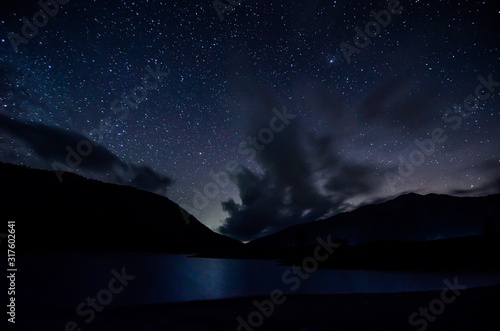 Night sky with clouds above lake in albanian nature near Fushe Stude, Albania