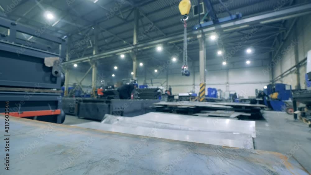 Large sheets of metal are lying in the factory facility. Large sheets of metal are lying in the factory facility.