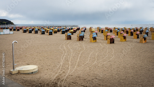 Fototapeta Naklejka Na Ścianę i Meble -  beach and beach chairs in rainy weather on the Baltic Sea beach in travemünde