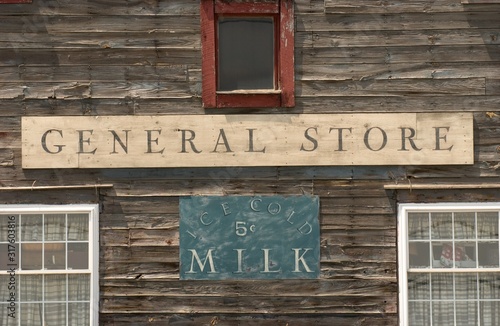 Fotografija General Store sign on a wooden building alongside with ice-cold milk sign under
