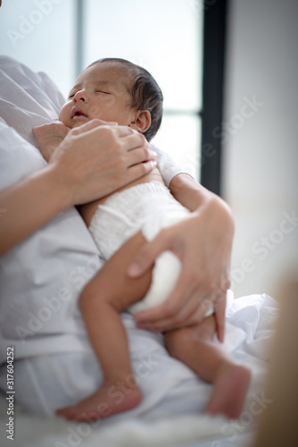 The baby is sleeping on a s...