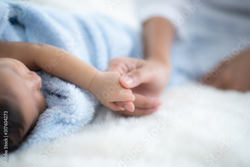 The baby is sleeping on a s...